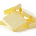 Piece of butter  on  white background
